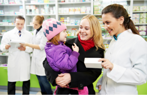 Pharmacist talking to a mother and a child