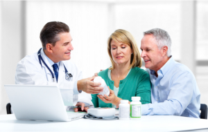 Couple talking to a pharmacist during a consultation