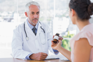 Pharmacist giving the customer a free antiobiotic